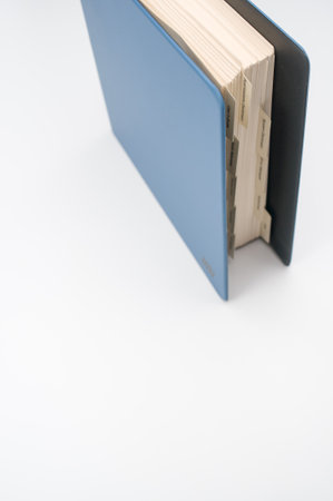 A vertical shot of a blue folder on a white surfaceの写真素材