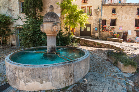 An old fountain in Vaison-La-Romaine city in Franceの写真素材