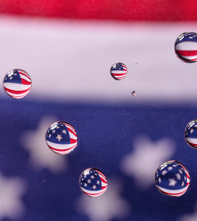 A macro shot of the reflection of the American flag in a several water dropsの写真素材