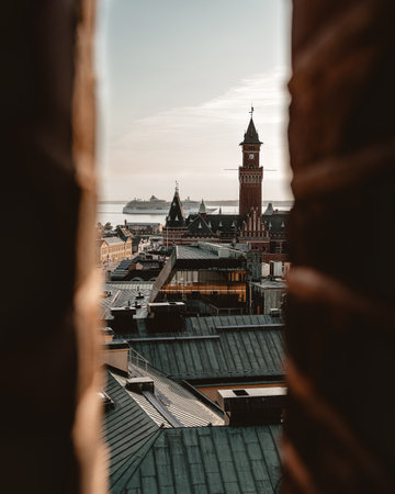 A vertical shot of a beautiful cityscape with dense buildings on the background of the sea under a gloomy skyの写真素材