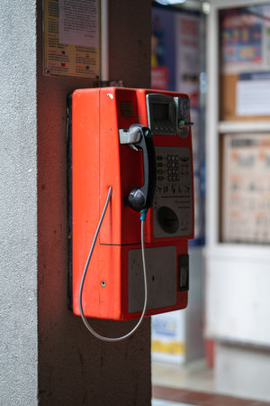 A vertical shot of a public coin telephoneの写真素材