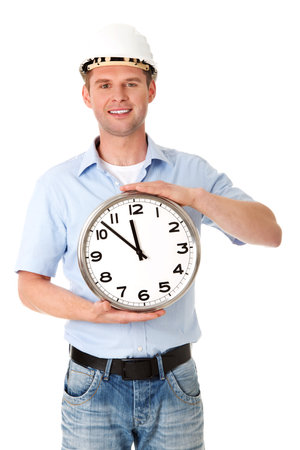 A vertical shot of man in helmet holding a clockの写真素材