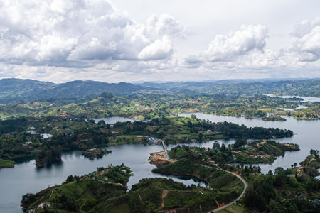 A shot of the Guatape Dam and hills with forests in Guatape, Colombiaの写真素材