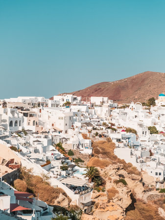 A vertical shot of buildings of Santorini - one of the Cyclades islands in Greeceの写真素材