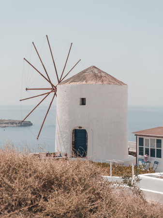 An old white windmill on the cliff in Santoriniの写真素材