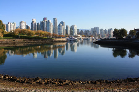 A beautiful shot of Vancouver city reflecting in clear calm water in Canadaの写真素材