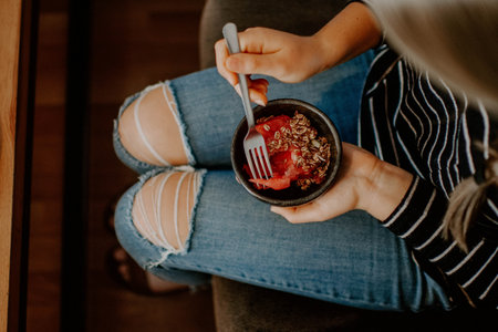 A top view of a female eating watermelon with oat flakesの写真素材