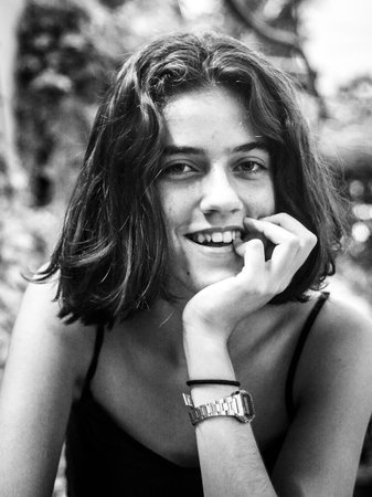 A vertical shot of a white Caucasian girl posing for a pictureの写真素材