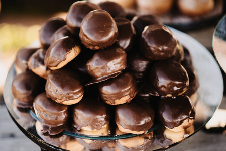 A closeup of a plate with chocolate profiteroles.の写真素材