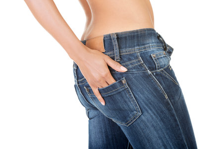 A sexy woman wearing fit jeans isolated on white backgroundの写真素材