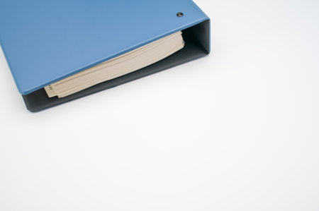 A closeup shot of a blue folder on a white surfaceの写真素材