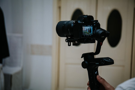 A cameraman shooting a wedding ceremony with a video cameraの写真素材