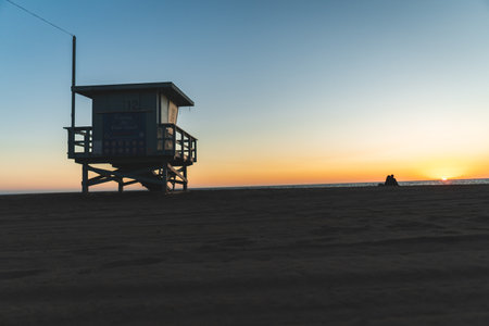 A silhouette of a rescue tower on a sandy beachの写真素材