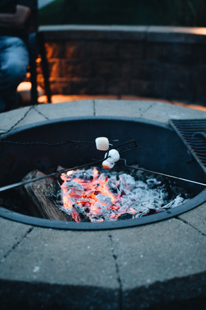 A vertical shot of marshmallows being roasted over a fire