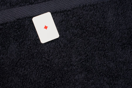 A closeup shot of a diamond card on a black carpet