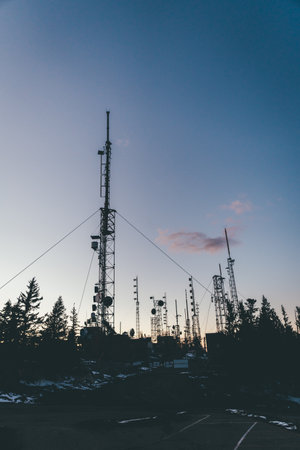 A silhouette of the radio tower and antenna