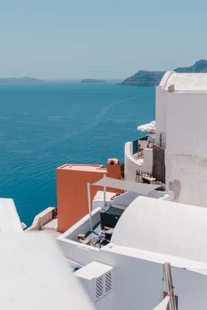 A vertical shot of the coastal buildings of Santorini in Greeceの写真素材