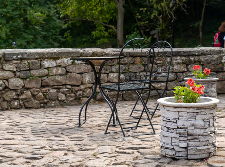 A small table and decorative chairs on a stone balconyの写真素材