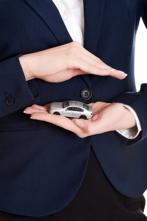 A small car toy in Caucasian woman hands
