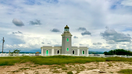 Los Morrillos Light surrounded by a field under a cloudy sky in Puerto Ricoの写真素材