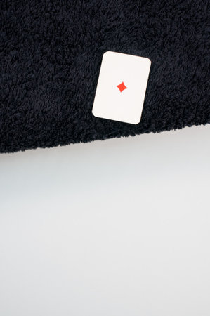 A closeup shot of a diamond card on a black carpet