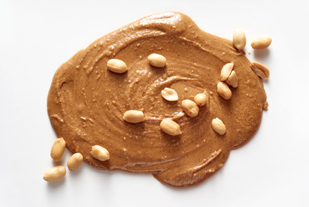 A top view of melted thick delicious brown chocolate with nuts on it