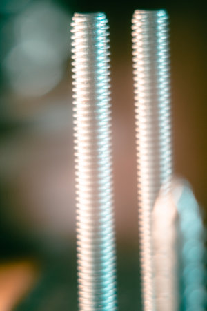 A closeup of the metal silver bolts against the dark background