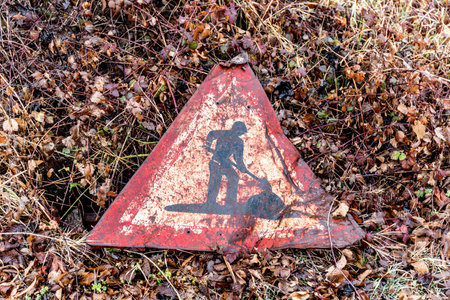A rusty old road sign in the dirtの写真素材
