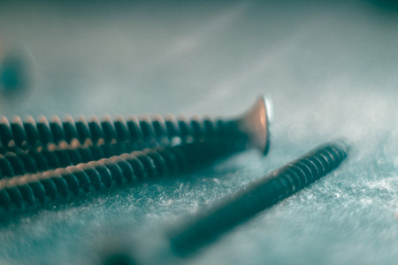 A closeup of the metal silver screws on  the gray  surfaceの写真素材
