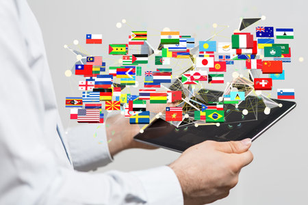 A 3D rendering of the world's flags and a male hand on a backgroundの写真素材