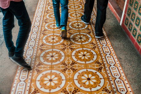 The people walking on the tiled floorの写真素材