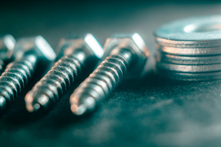 A pile of screws on a dark backgroundの写真素材