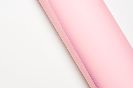 A closeup of pink fabric on a white surface with copy spaceの写真素材