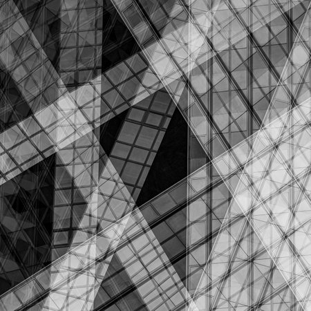 A grayscale shot of the windows of a glass skyscrape