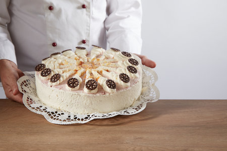 A man serving a tasty cake