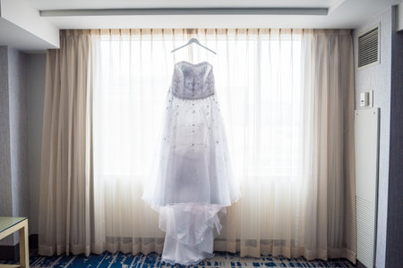 A beautiful wedding dress by the windowの写真素材