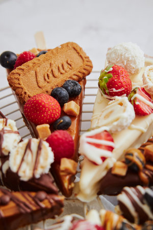 The appetizing tasty cheesecake with fruits on sticksの写真素材