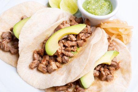 A closeup of delicious fresh tacos with beef and avocado
