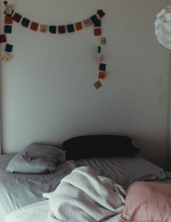 A cozy bedroom with shots hanging on the gray wall