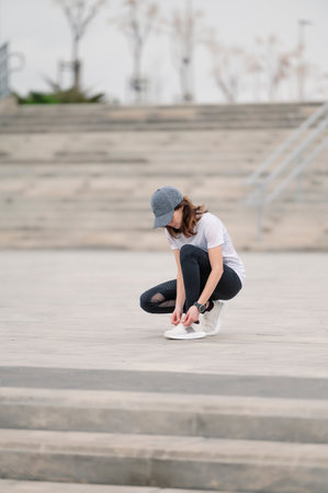 A young female jogger tying her shoelacesの写真素材