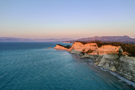 A landscape of cliffs surrounded by the sea during the sunrise in the morningの写真素材