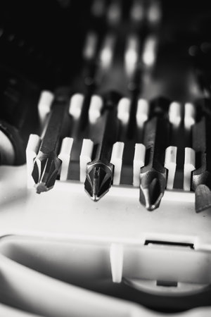 A vertical shot of a new set of screwdriver bits in a box for tools