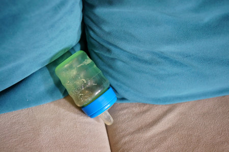 A sippy cup on soft pillows