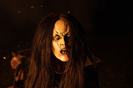 A closeup shot of a female wearing a Halloween costume posing outdoors