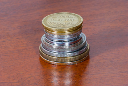 Group of coins without value on wood texture. Guatemala, central america.