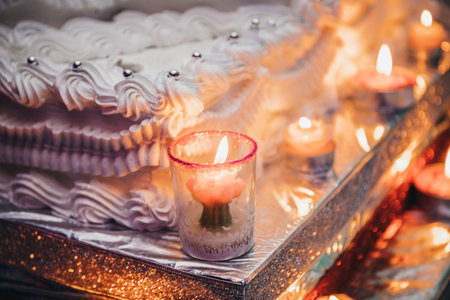 A selective focus shot of the wedding cake and candlesの写真素材