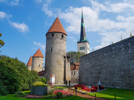 Town walls of old town Tallin in Estonia, with one of the many Churches behindの写真素材