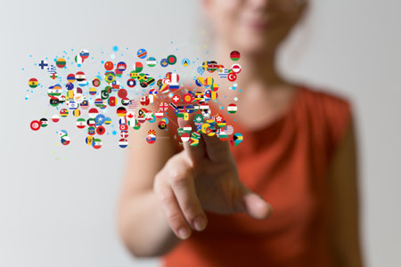A 3D rendering of the world's flags and a female hand on a blurry backgroundの写真素材