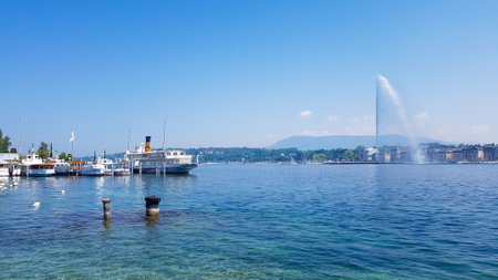 Boats moored next to the water feature in Lake Geneva on a sunny dayの写真素材