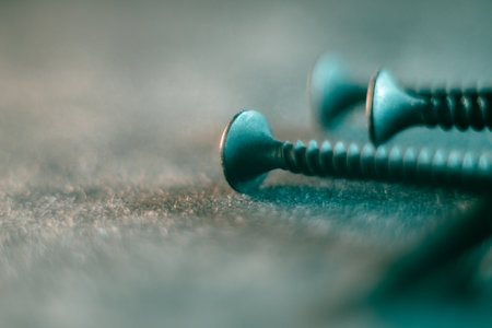 A pile of screws on a gray backgroundの写真素材